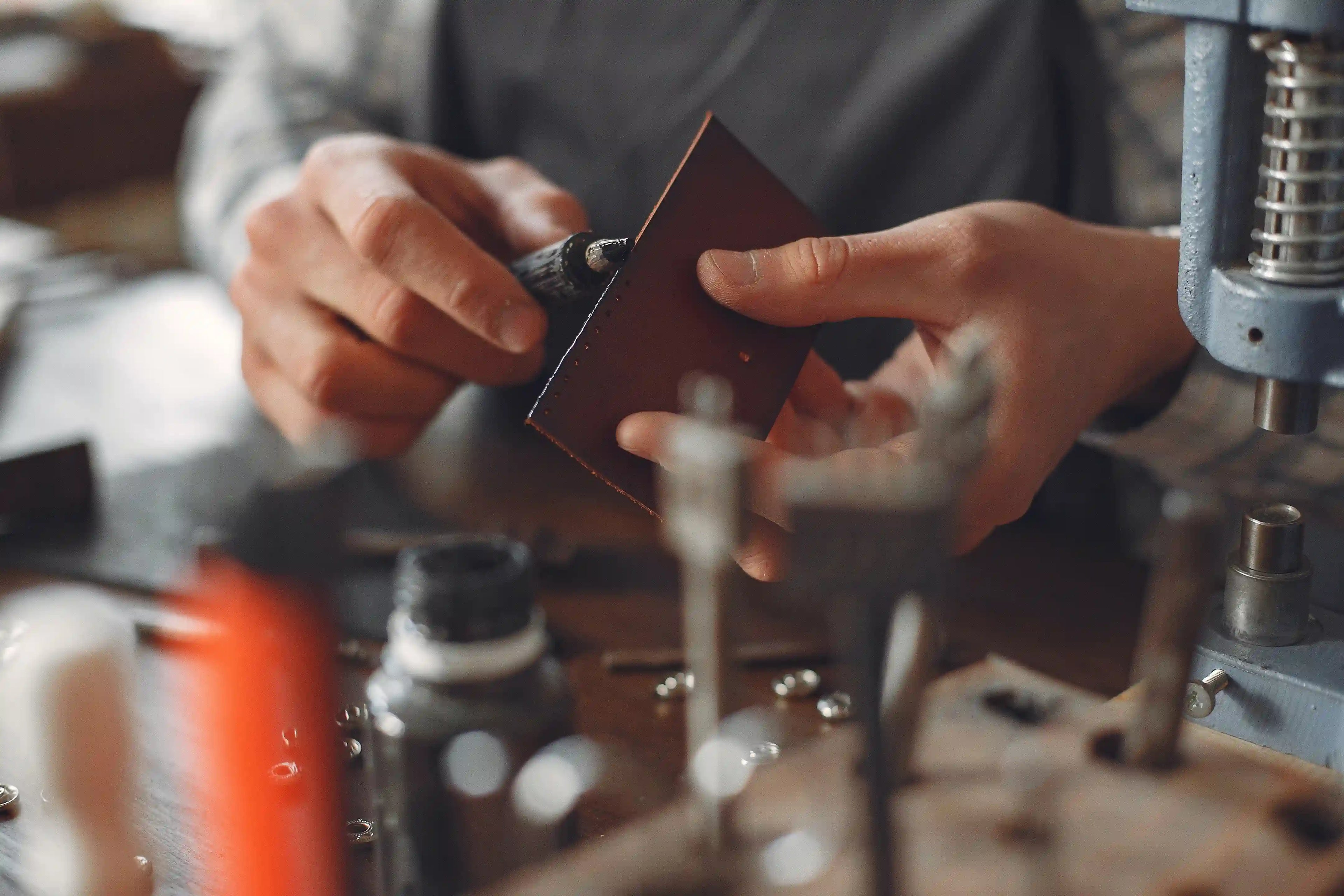 Artisan crafting a piece of handbag